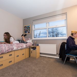 2 students in their boarding room working