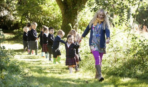 students walking along a woodland path