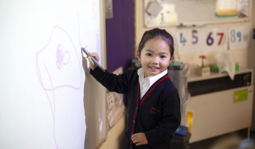 student writing on whiteboard