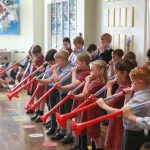 Students playing with large plastic trumpets