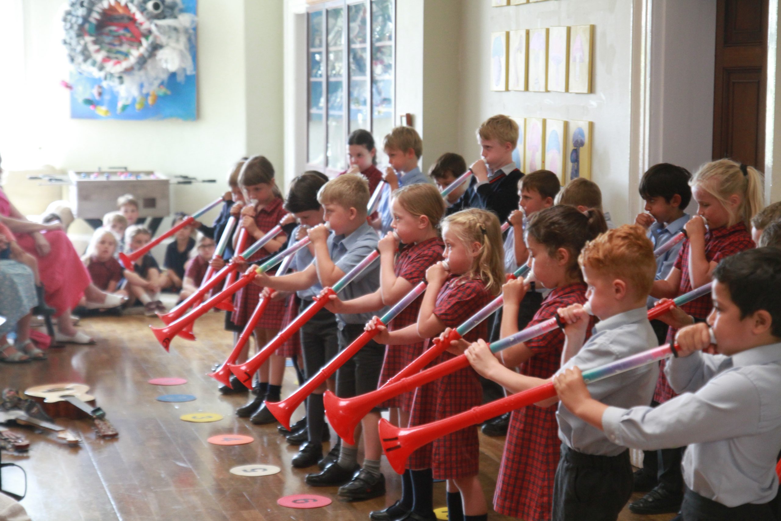 Students playing with large plastic trumpets