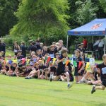 Students running across the track for sports day