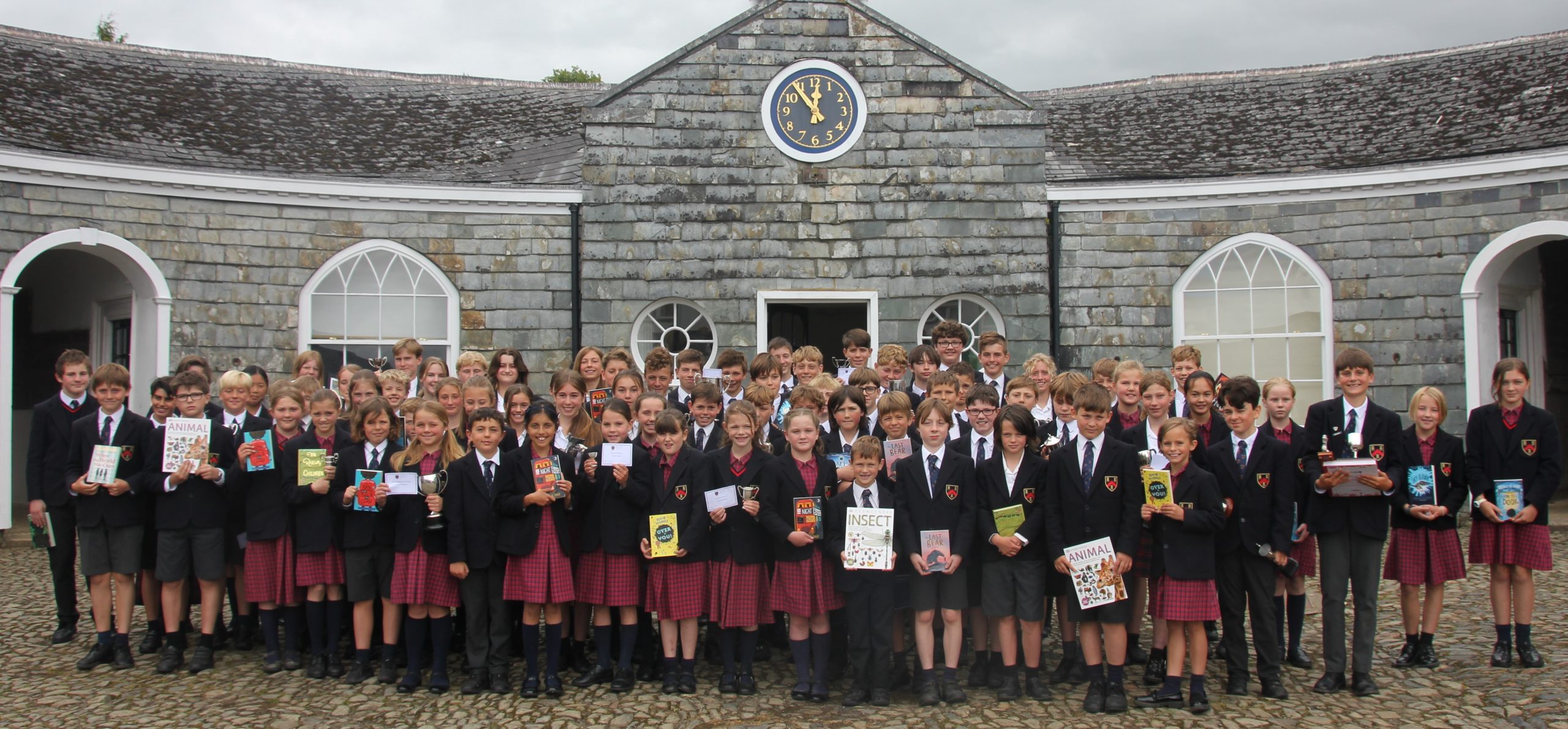 students in a group with their animal and insect books