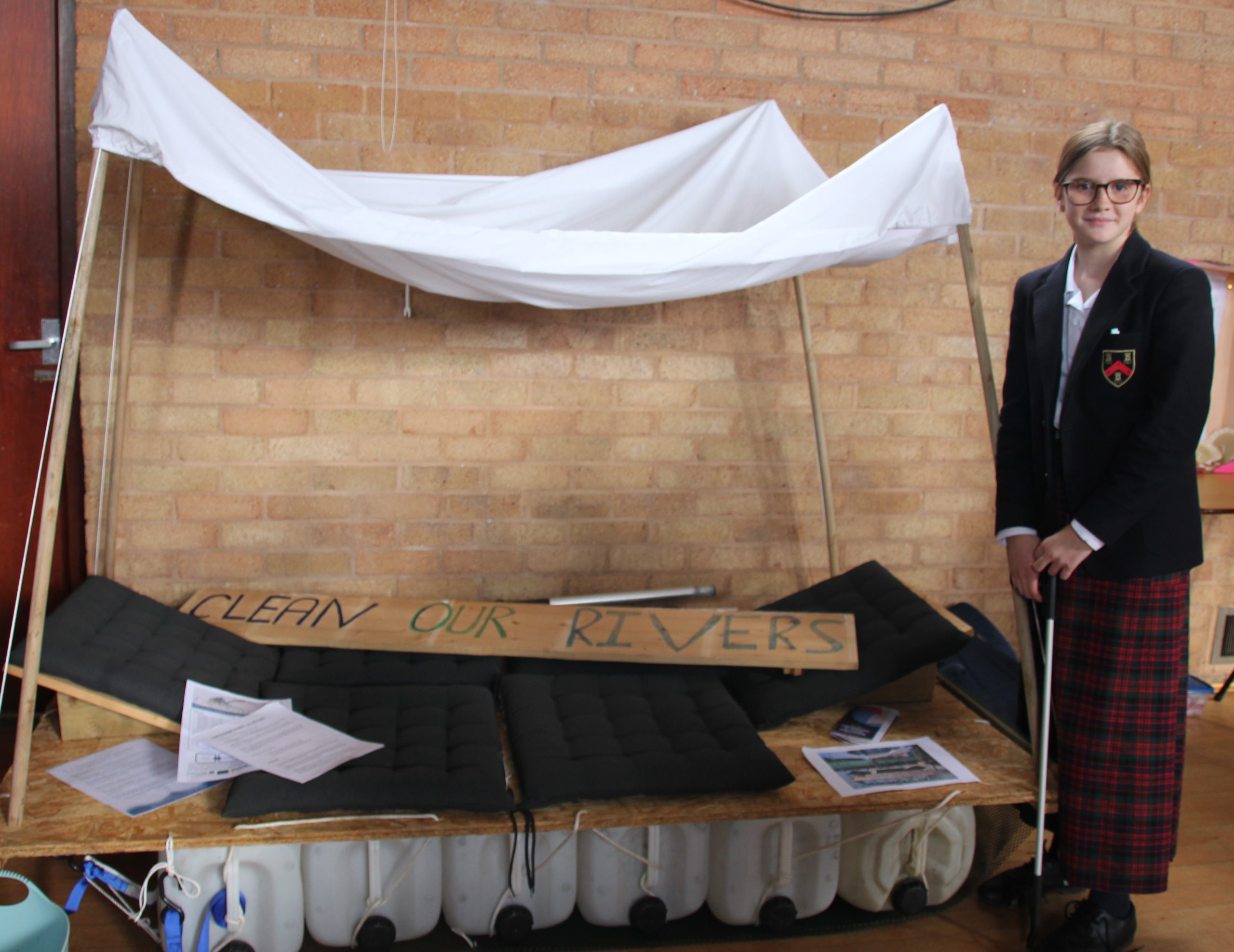 Student with litter picker and a display all about the amount of waste we produce