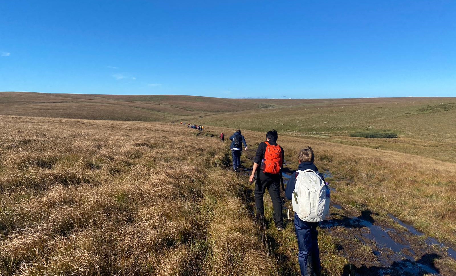 students walking along the mountain path