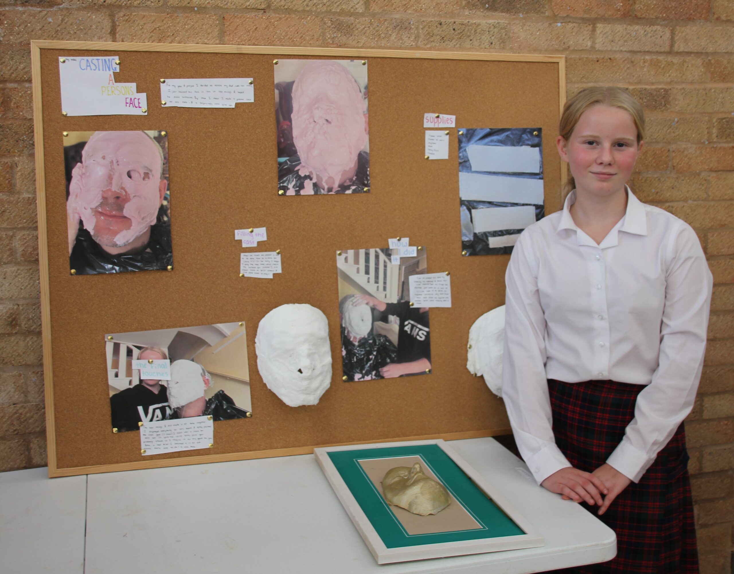 student stood next to art display