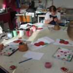 students painting poppies