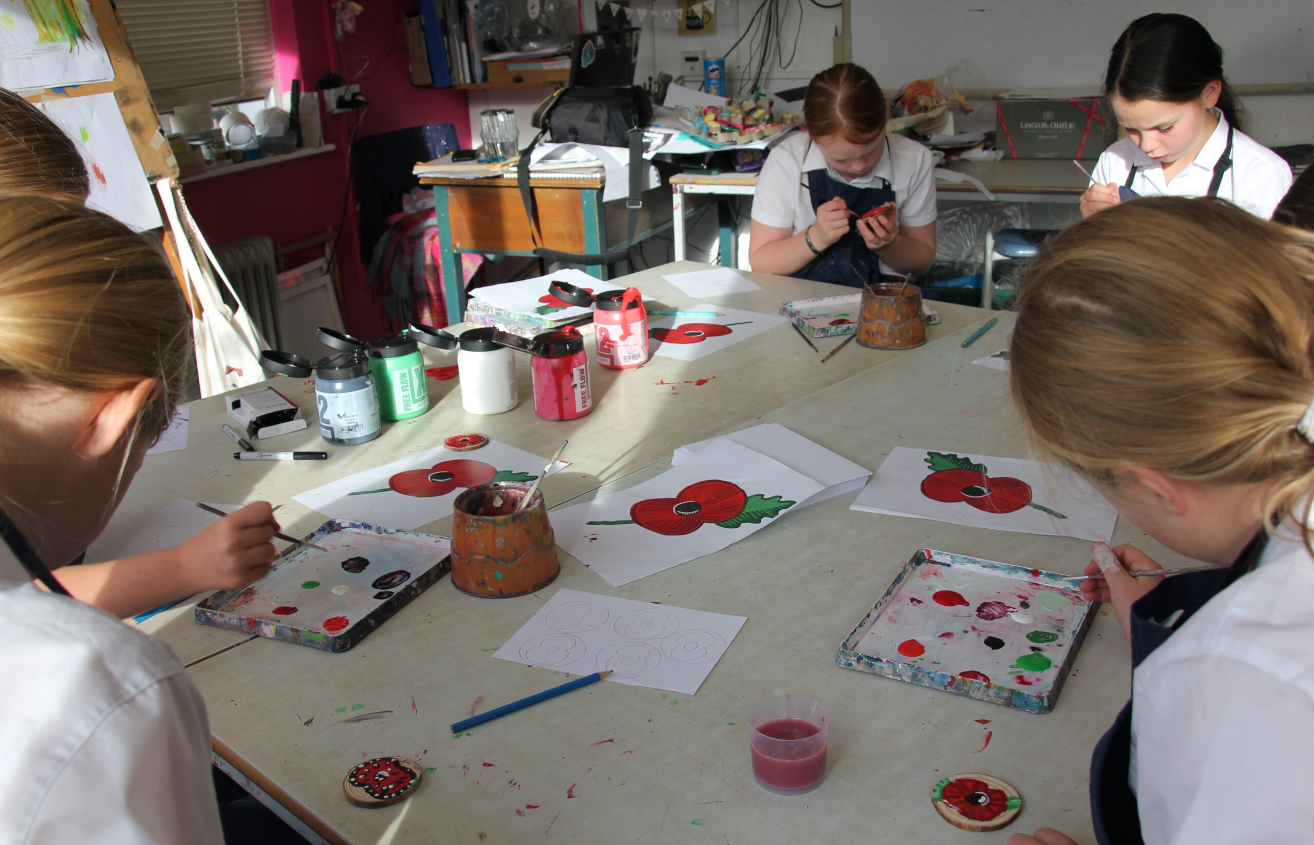 students painting poppies