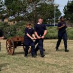 students walking and pulling a cart