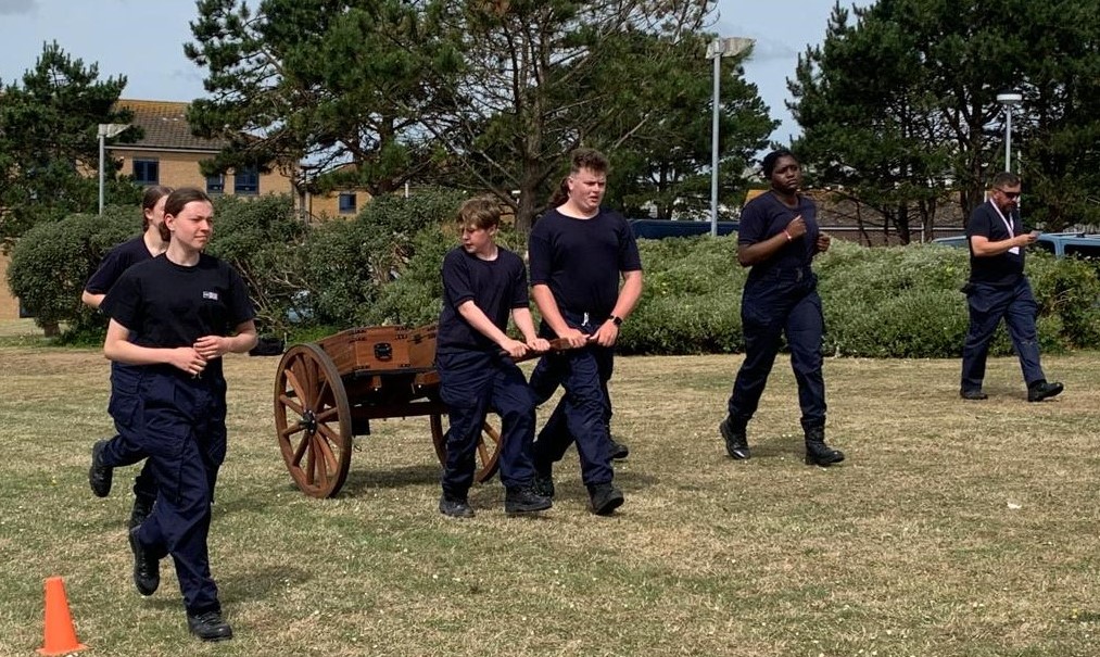 students walking and pulling a cart