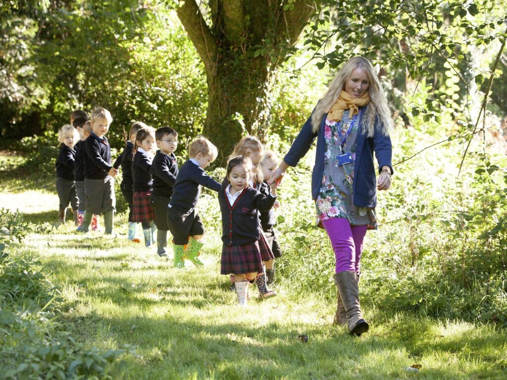 students walking along a woodland path