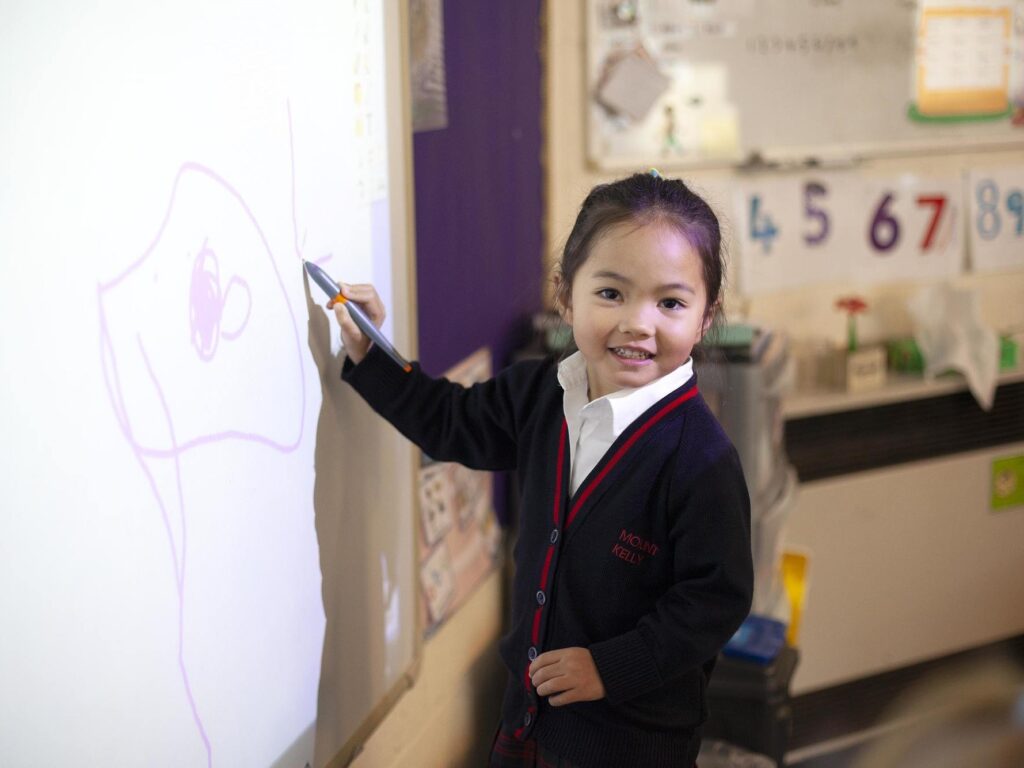 student writing on whiteboard