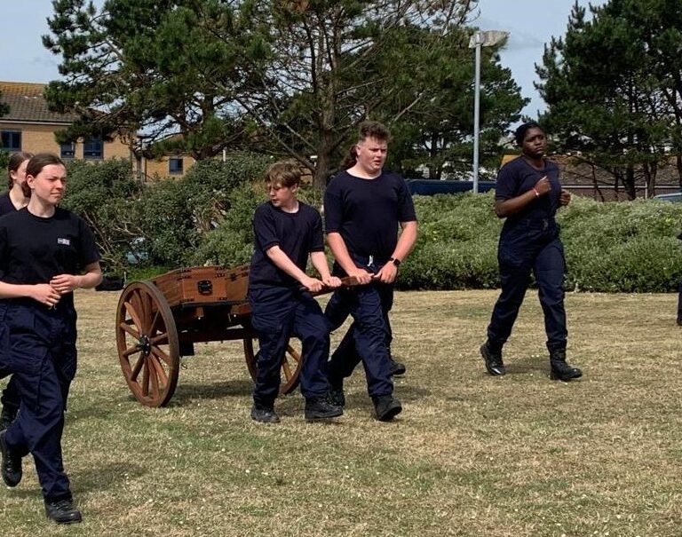 students walking and pulling a cart