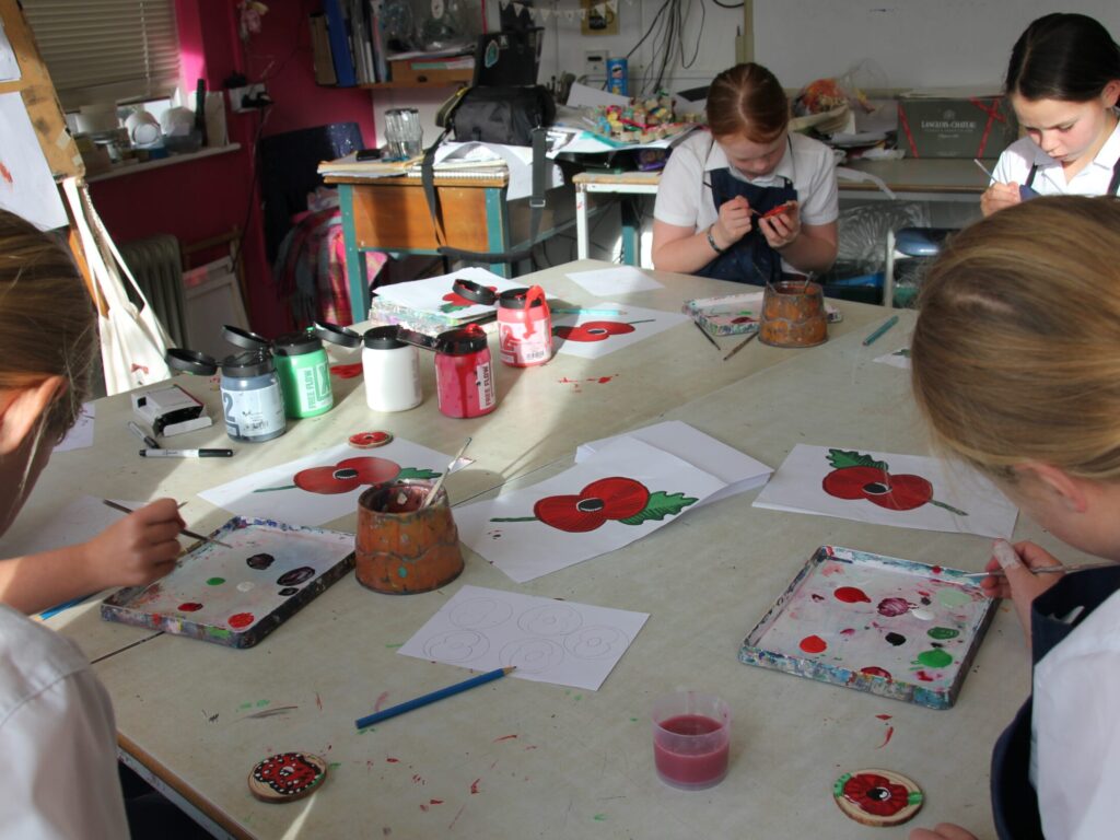 students painting poppies