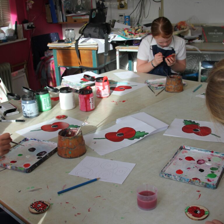 students painting poppies
