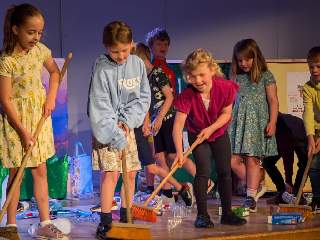 pre-prep students brushing the floor