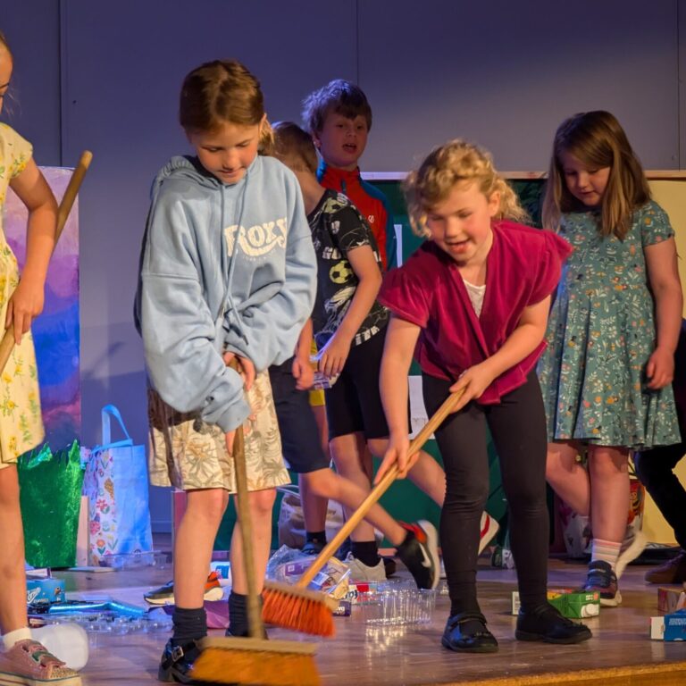 pre-prep students brushing the floor